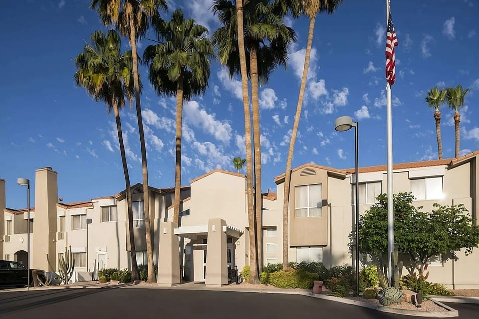 Arrive with ease at a bright, palm-lined entrance.