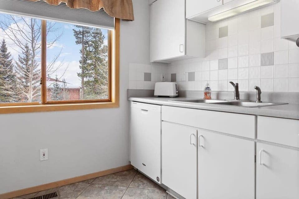 The kitchen is a light-filled space with a large window providing some tranquil views while you prepare your meal.