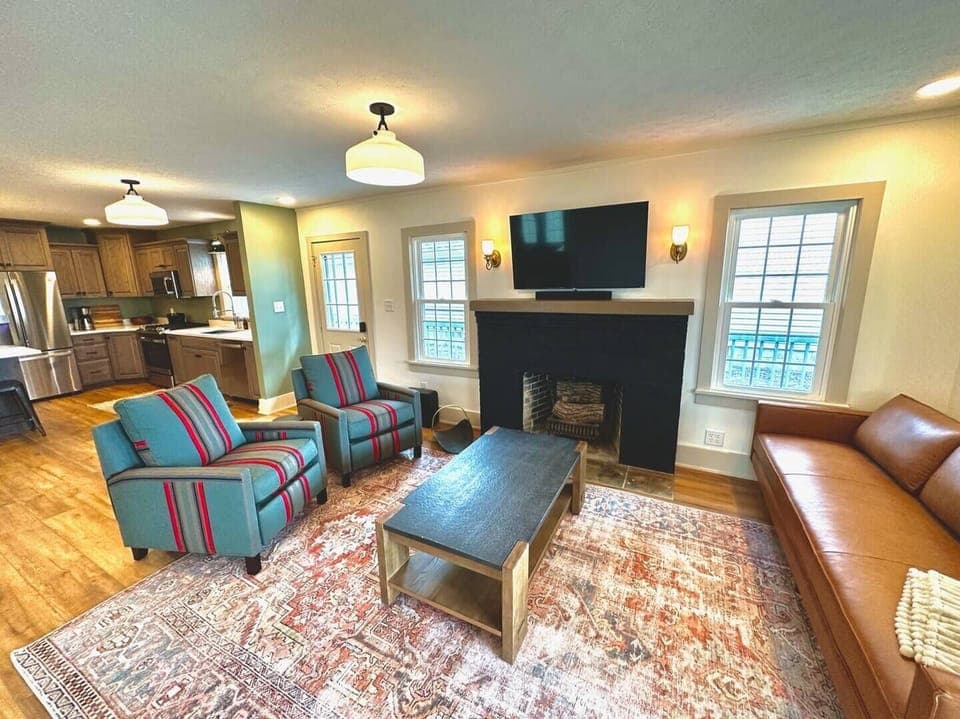 Living room w/ recliners, couch, 50" SmartTV, Sonos sound bar w/ subwoofer.