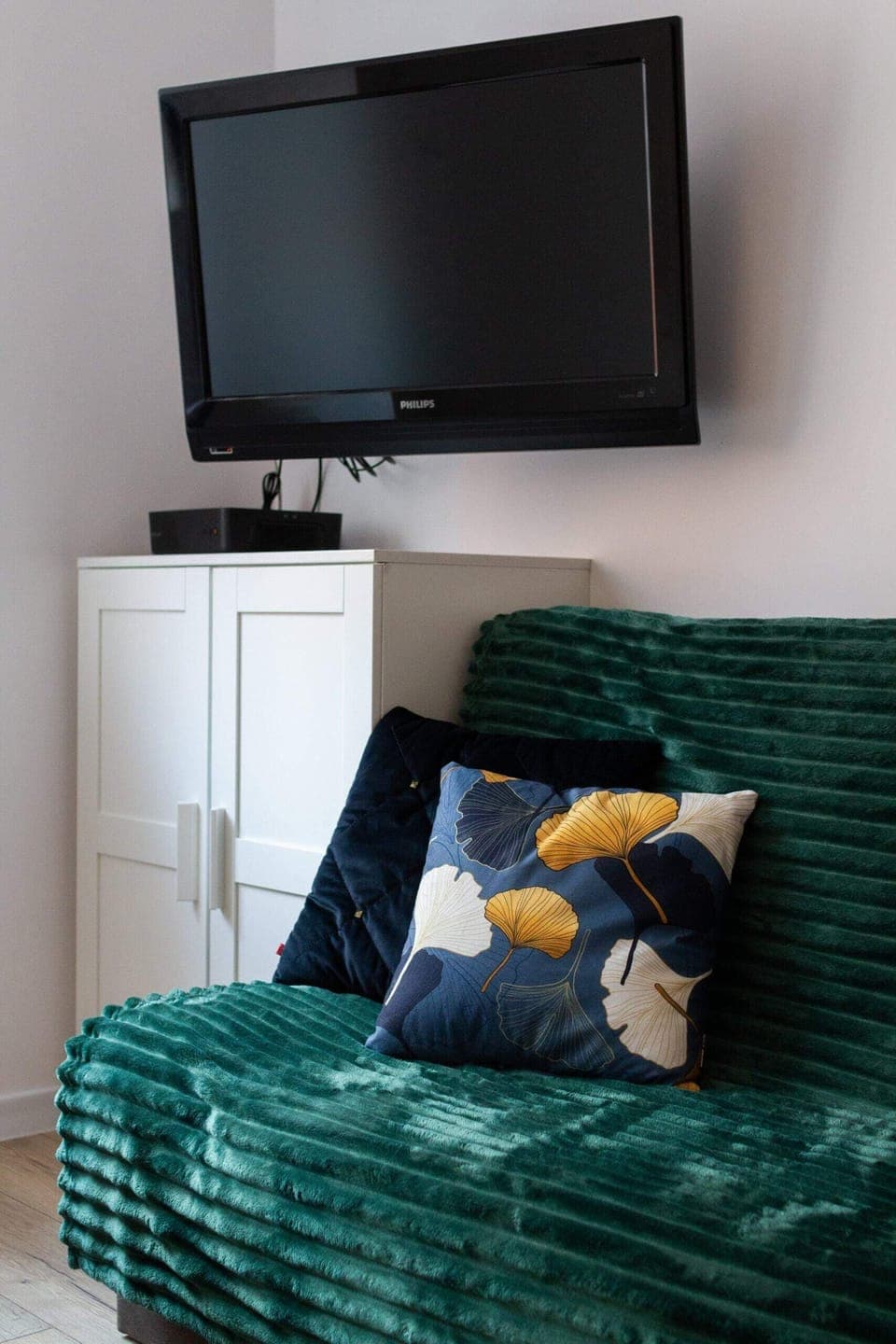 A mounted TV positioned above a white console, blending entertainment with minimalist design.
