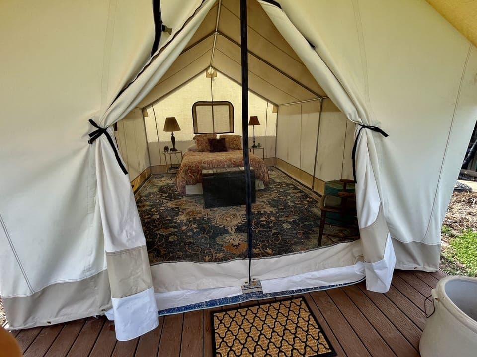 Guests can use screen door for a fresh breeze and garden view from the bed. 