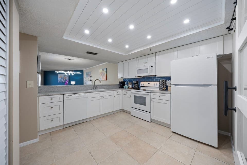 Fully stocked custom kitchen open to the living room.