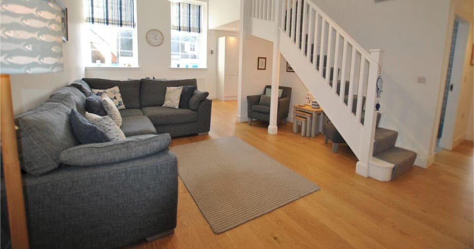 Lounge with wooden floor and staircase