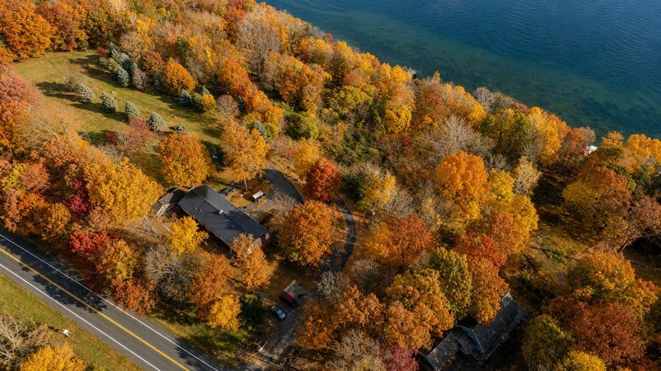 Arial view of the townhomes surrounded by beautiful trees and Cayuga lake.   Experience the vibrant colors from above and the tranquil waters below. 