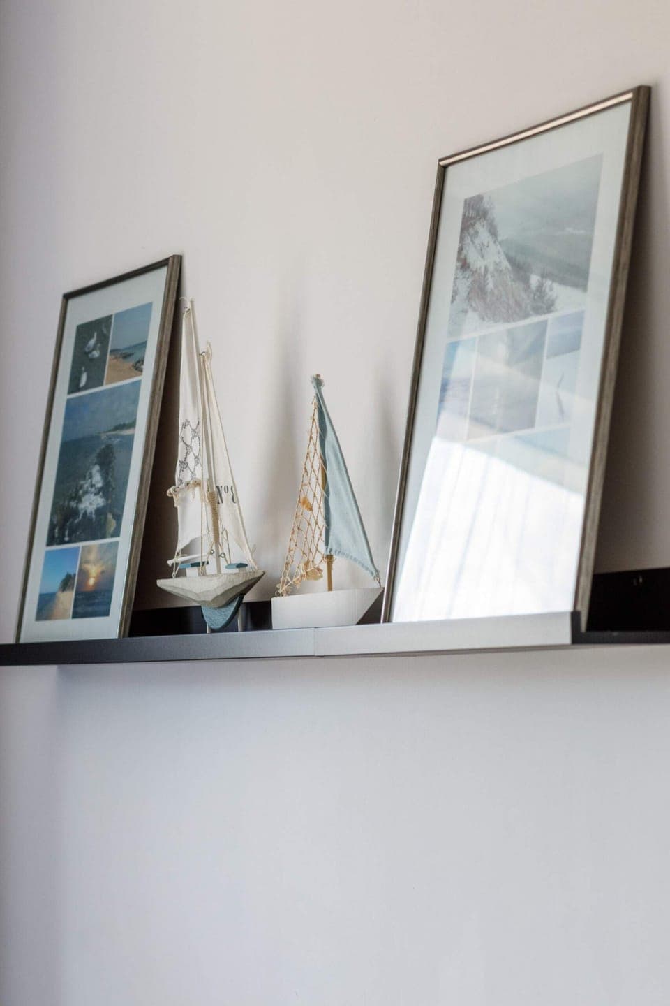 A collection of framed art leaning on a shelf, adding a stylish touch to the room.
