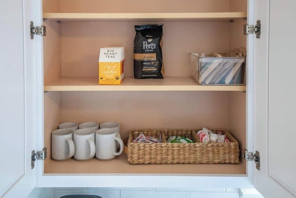 Start your morning with a cup of joe! Find coffee mugs, creamer and sweetener in the cabinet above the coffee maker 