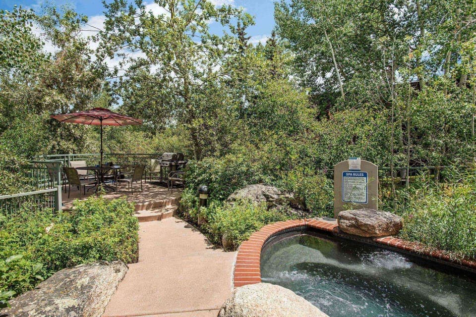 Guests have access to a grill, seating area and grotto style hot tub during their stay.