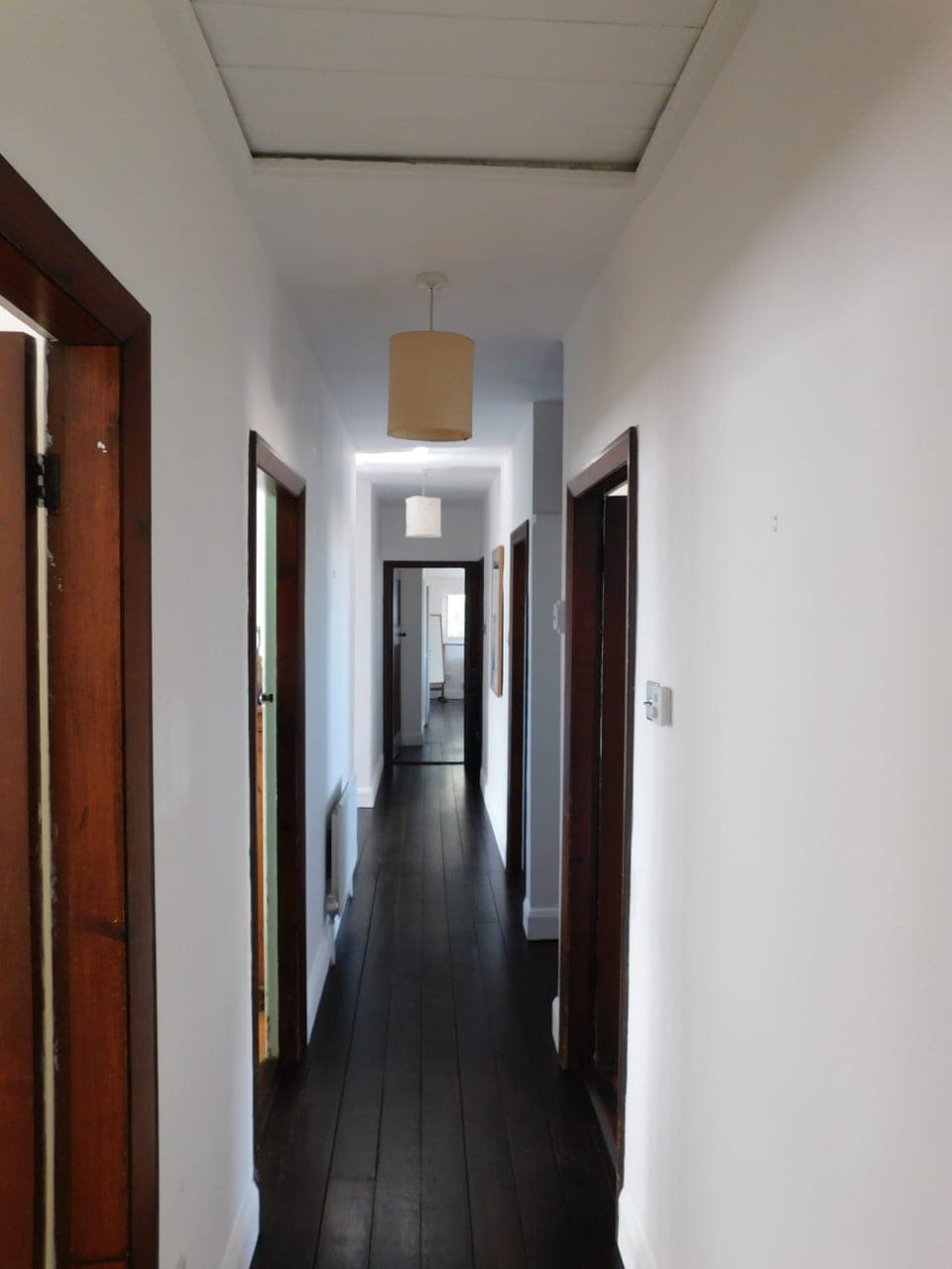 Looking from the main bedroom to the end of the house towrdsthe two twins rooms