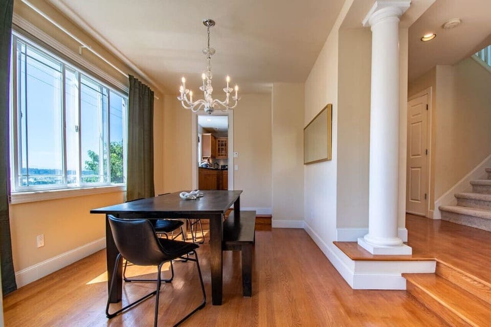 Charming dining space adorned with a beautiful chandelier, creating a warm and inviting atmosphere