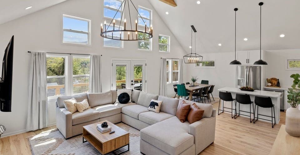 Relax in the large living and dining space where the vaulted ceilings and natural light create a calm and peaceful retreat after a long day of exploring.