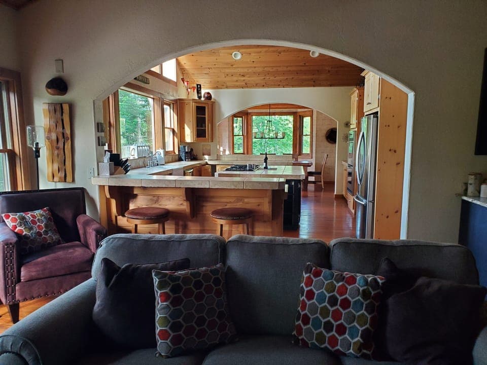 Main living room looking into the kitchen.  2 peninsulas with stools.  
