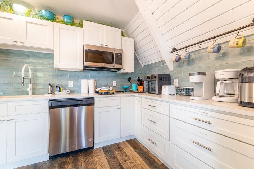 Featuring a dishwasher, microwave, two burner stove top, air fryer/toaster oven.