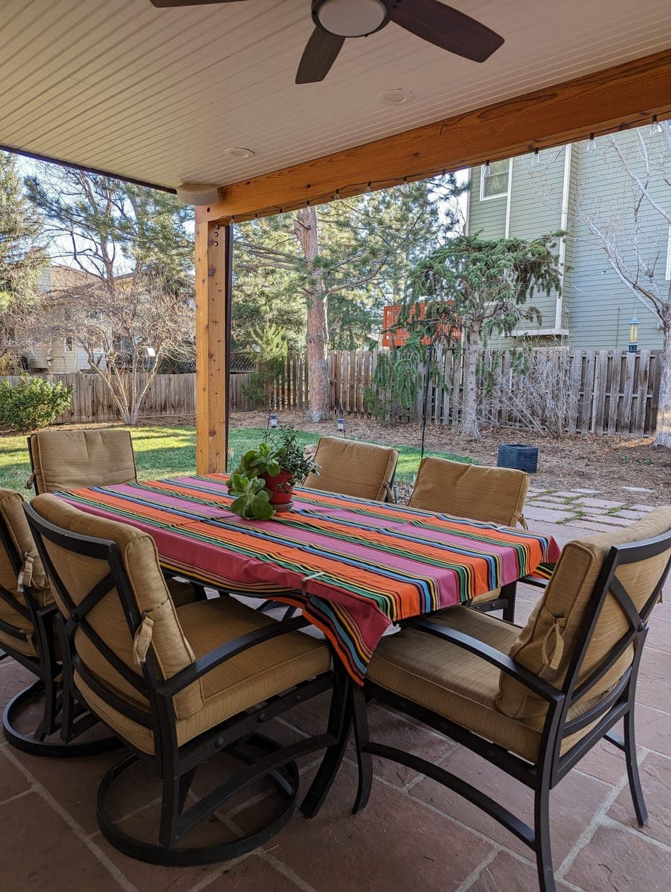 Enjoy the comfort of covered seating in the inviting backyard.