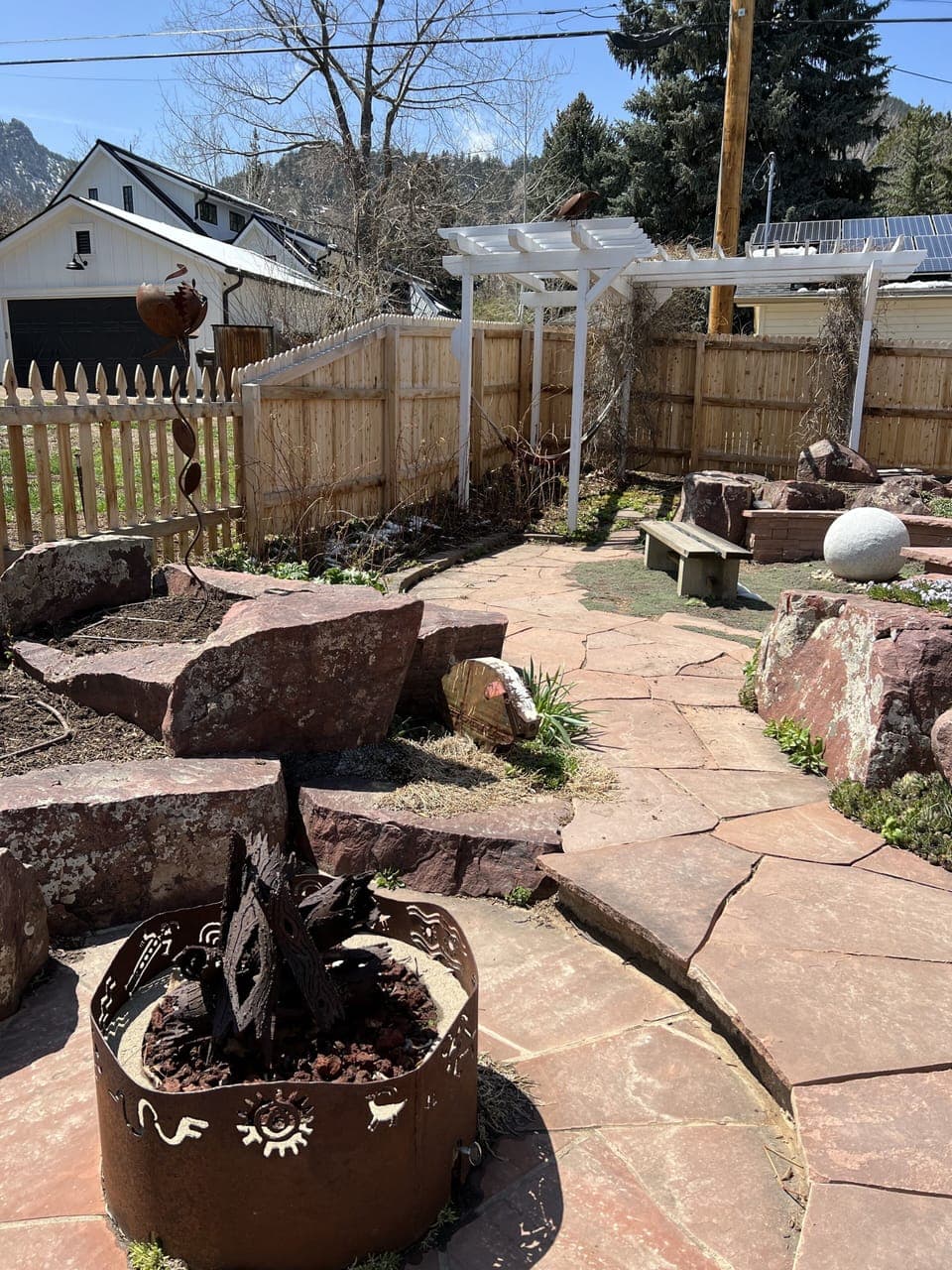 fire pit, fountain, and hammock in the backyard