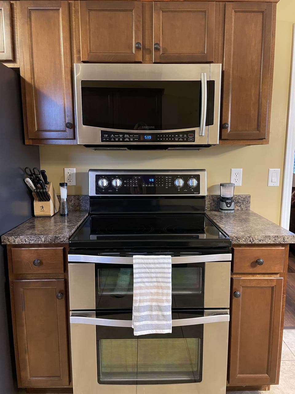 Kitchen includes refrigerator/freezer, range/double oven, microwave, knife set. 