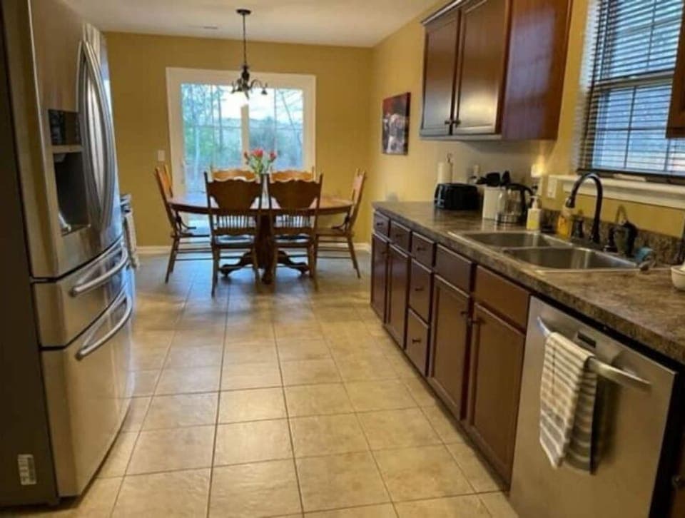 The kitchen is fully stocked with pots, pans, dishes, glasses, and dishwasher. 