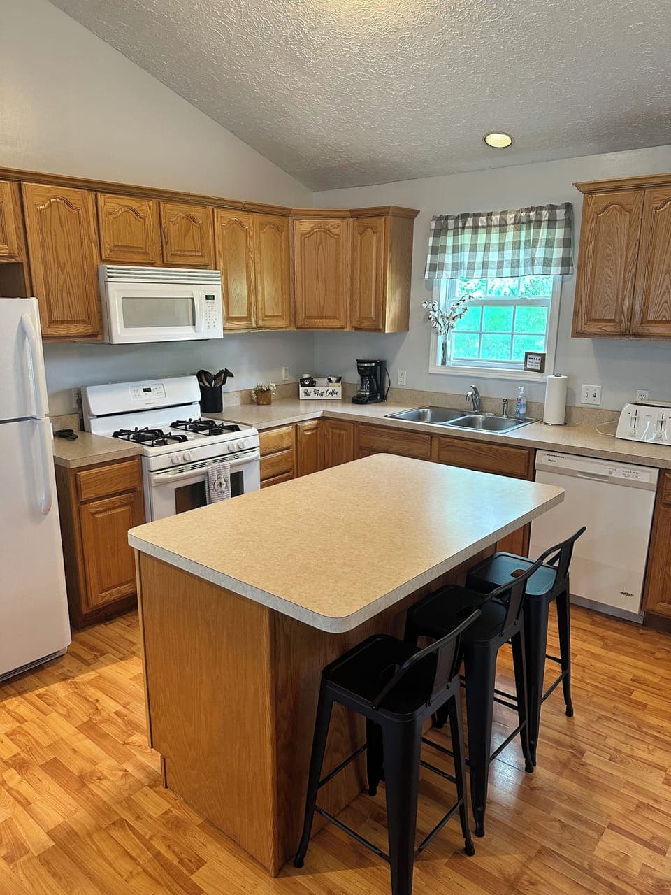 Fully stocked kitchen with island and counter seating. 