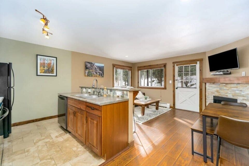 Kitchen with breakfast bar, dishwasher, fridge, range, and microwave.jpg
