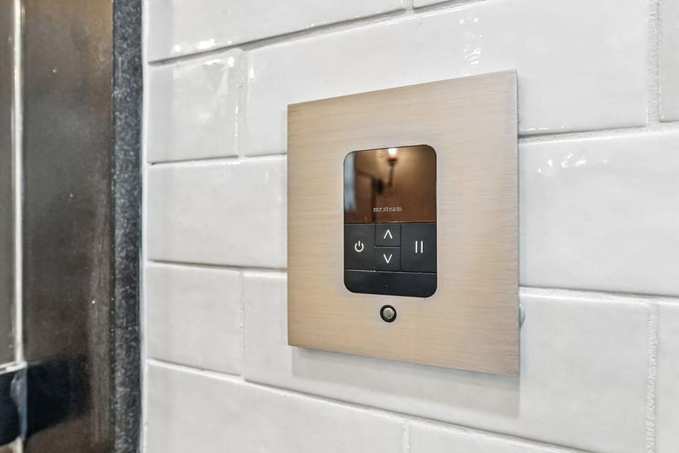 Wall-mounted Mr. Steam digital steam shower control.