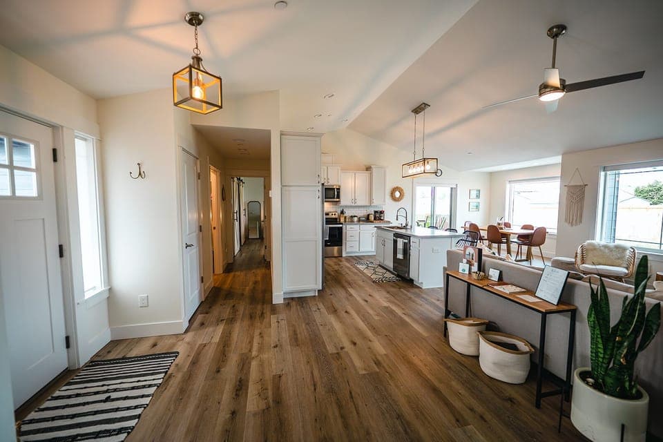 Entry, hallway to primary bedroom, kitchen, and living room 