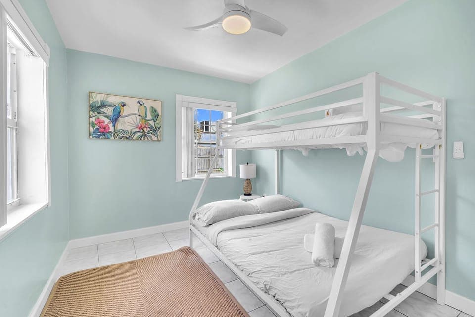 Guest bedroom has a decently sized bunk bed with plush pillows and comfy sheets.