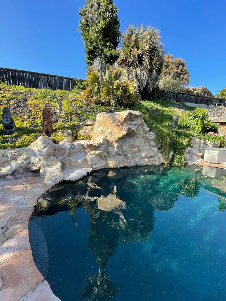 Pool with waterfall and rocks to jump from