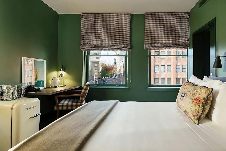 Stretch out on a plush bed in a serene corner room.