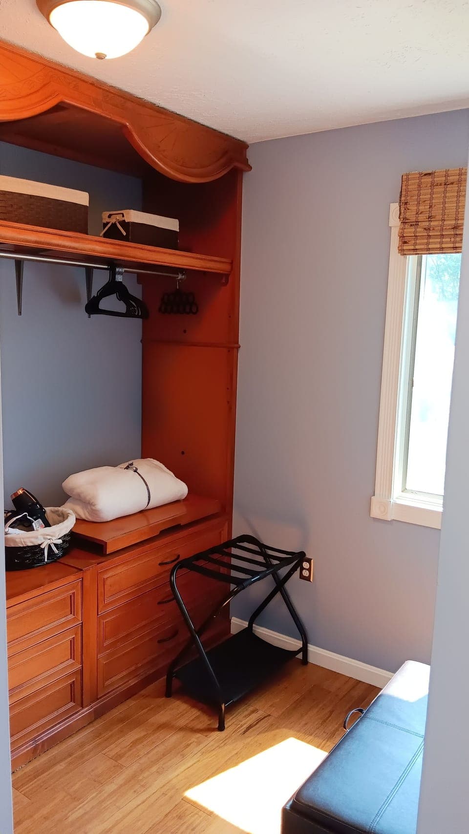 Walk-in master closet is the perfect spot to get ready in with a bench & mirror.