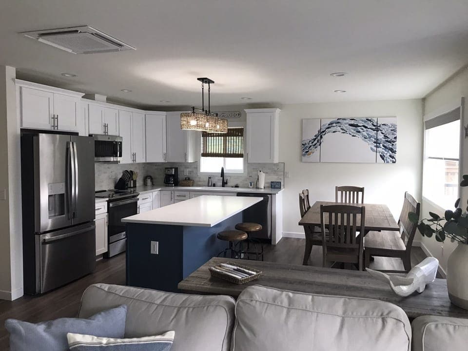 Kitchen and dining area with island. Table seats 8-9 comfortably with bench. 
