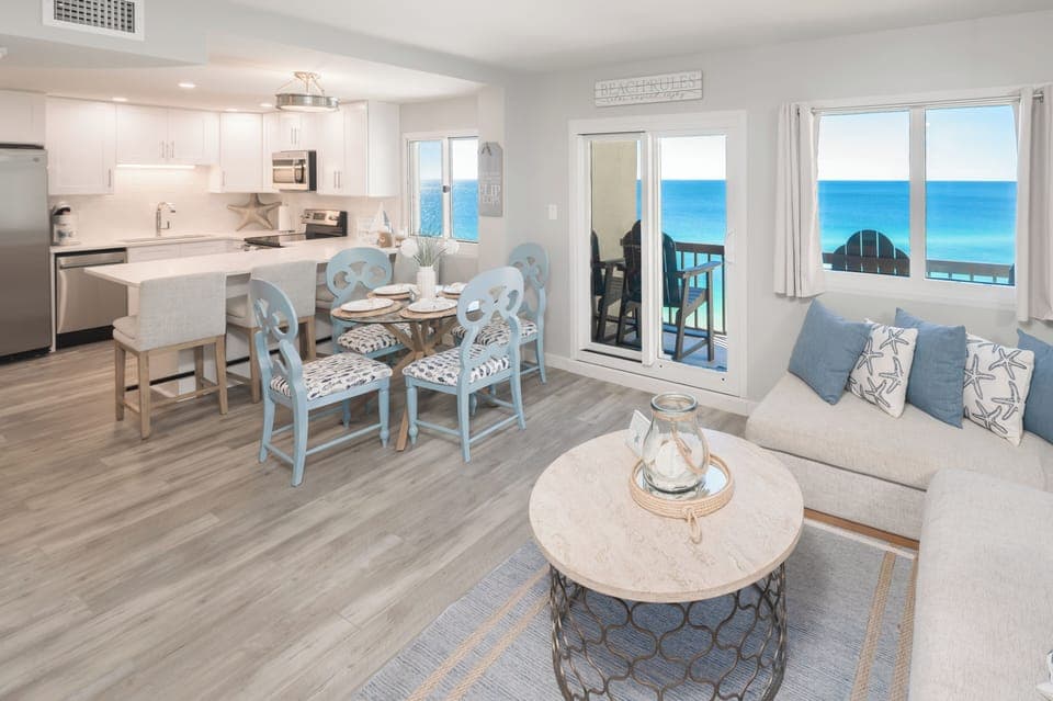 Large downstairs space with kitchen table and barstools. 