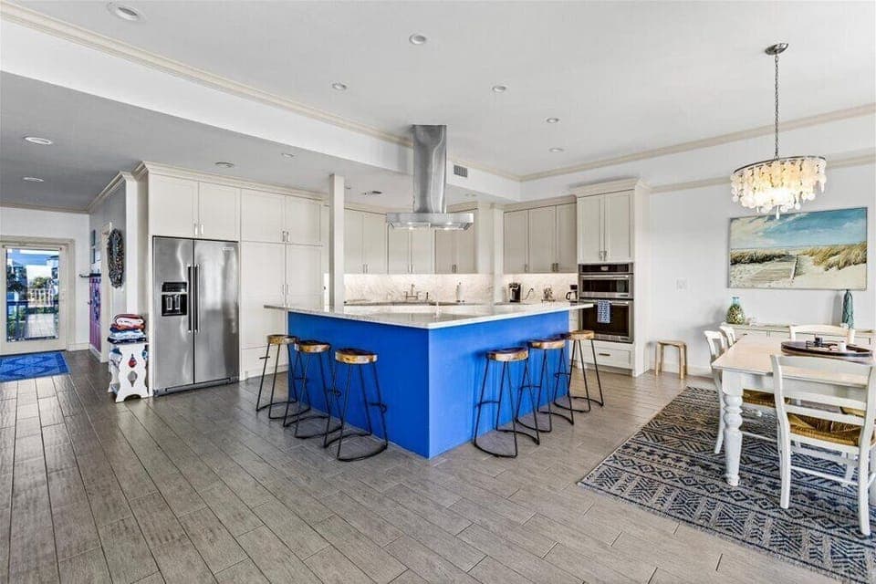 Prepare meals in style with a vibrant island and modern appliances!