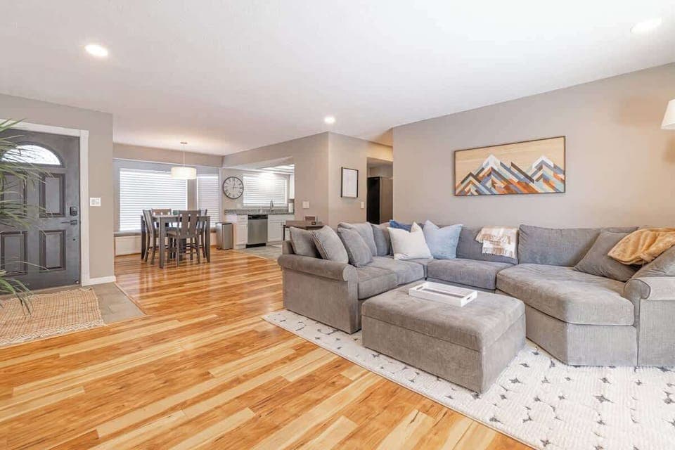 Living room with recessed lighting on dimmer.75 " Smart TV.XL Doggie door.Bar cart with glasses.