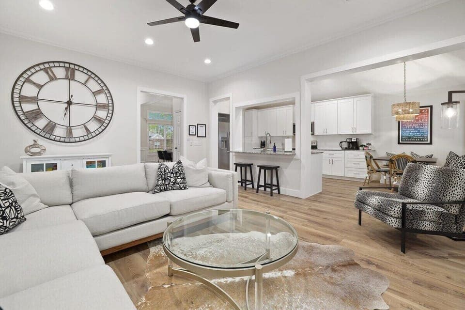 Here, you'll find a plush sectional, a 65-inch Sony Smart TV, working electric fireplace and large windows with lots of natural light.