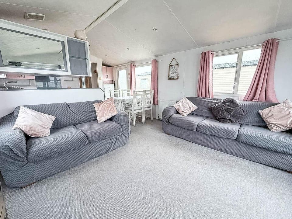 The holiday home living room features a fireplace that adds warmth and charm to the space.