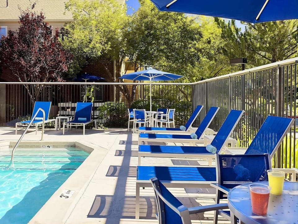 Stretch out on plush loungers with drinks beside the water.
