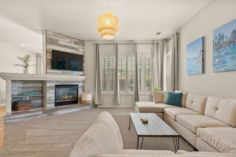 Lounge in our open concept living room with a fireplace and Roku Smart TV. We have free Netflix, HBO Max, and Hulu included!