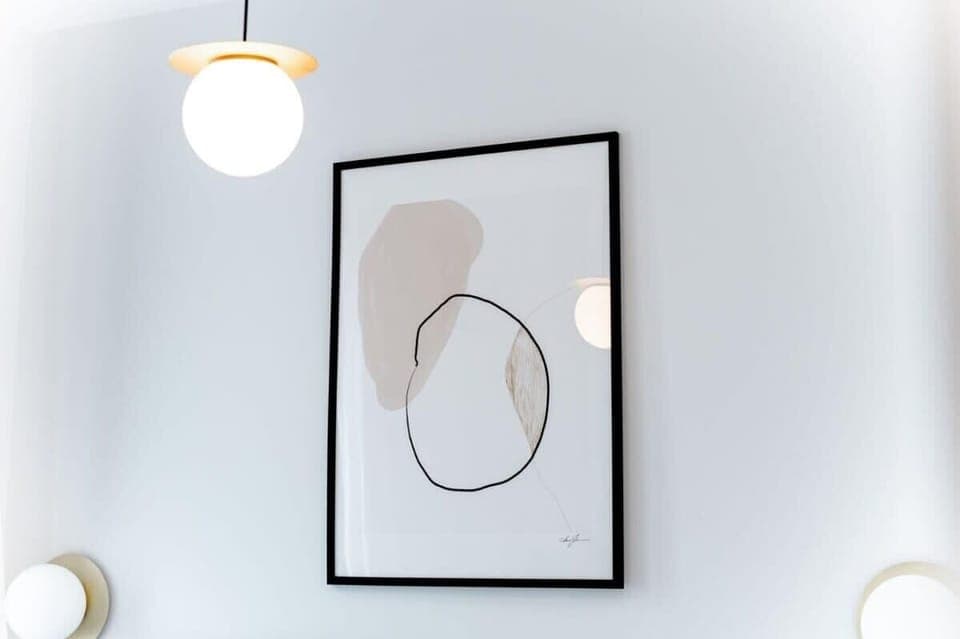 Minimalist wall art and soft lighting add a stylish, modern touch to the apartment's overall aesthetic