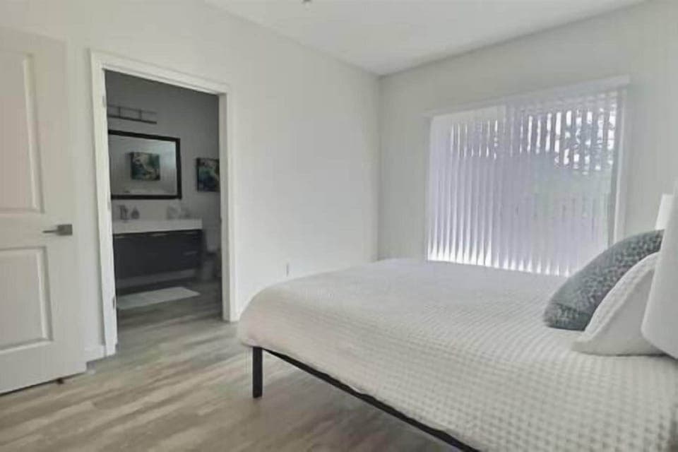 Master suite with queen bed, ensuite bath, and patio access with beautiful olive orchard views.