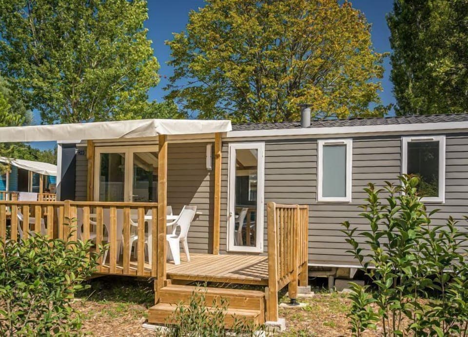 Step into a welcoming outdoor space where the terrace with a plancha invites family barbecues amidst a lush, green environment.