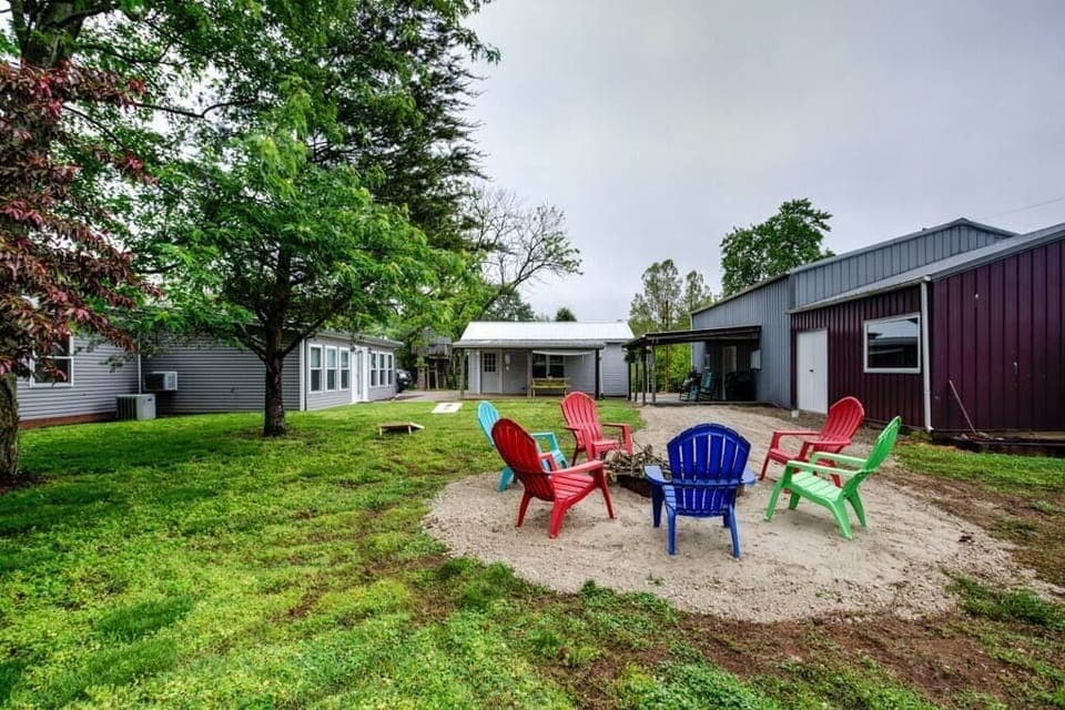 Outdoor area with corn hole boards, fire pit and children's tree swing
