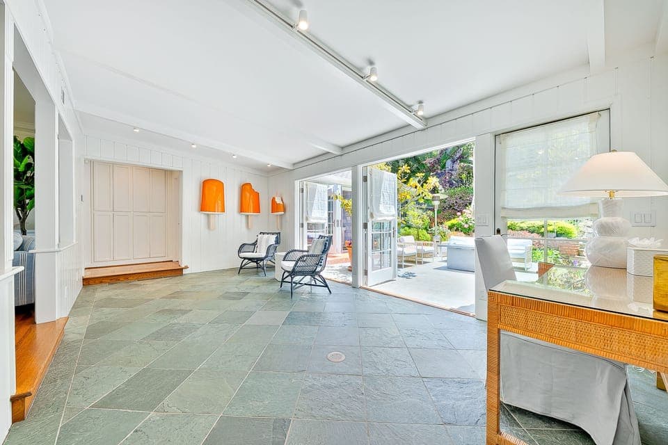 Relax in the sunroom featuring slate floors, skylights, and access to the outdoor lounge—ideal for morning yoga or evening cocktails.