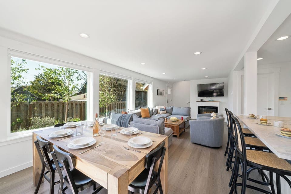 Dining room open to Living room with electric fireplace, Streaming TV, and kitchen with Bar seating.