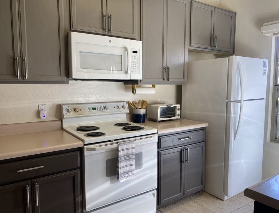 Beautiful two toned grey kitchen.  Stove has been replaced since this photograph