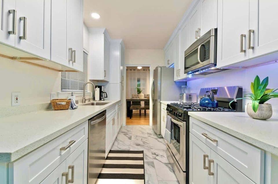 Kitchen and large refrigerator, providing ample storage for your culinary delights, ensuring your ingredients remain fresh and easily accessible throughout your stay...