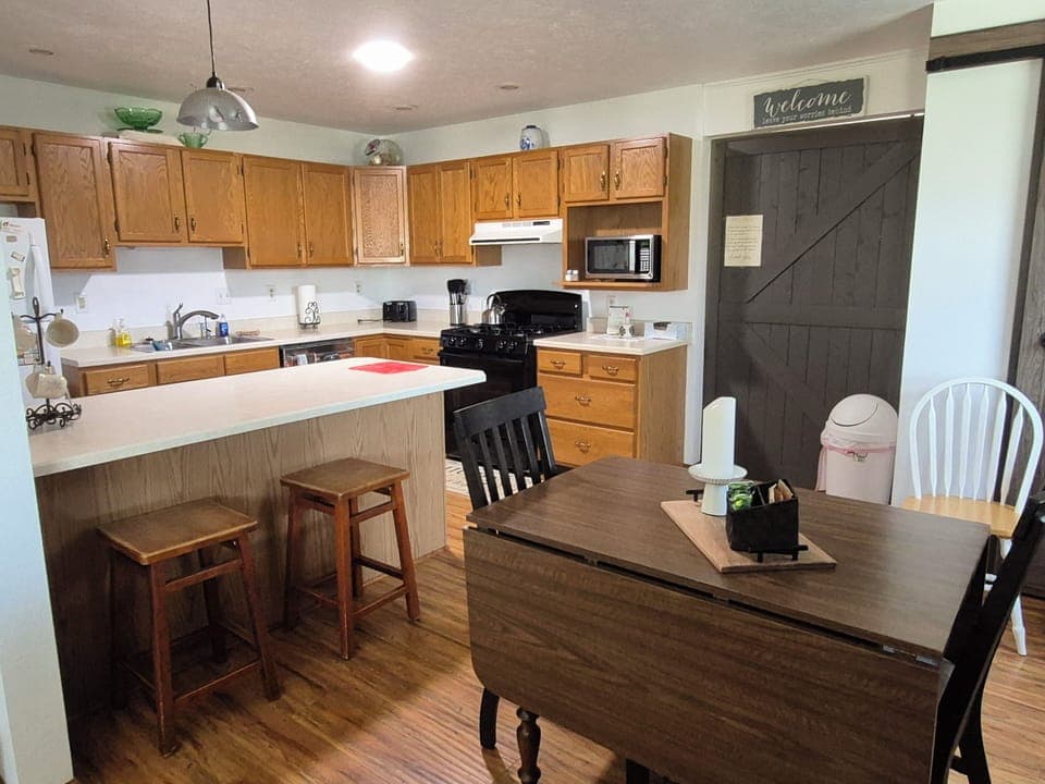 dining room & kitchen with stove, oven,  microwave & fridge.  