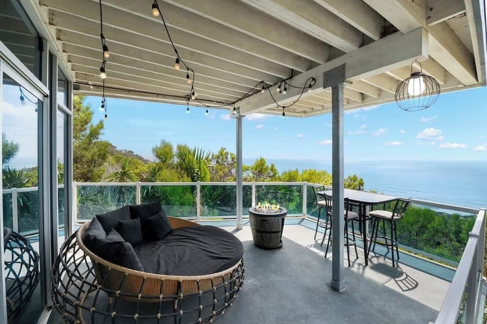 Unwind in comfort with a round wicker chair and bar table set, perfectly positioned to enjoy panoramic ocean views from the wraparound balcony. Whether it’s morning coffee or evening drinks, this space offers the ultimate retreat. 