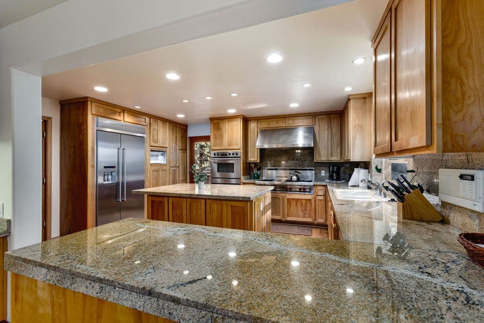 The spacious chef’s kitchen features sleek granite countertops.
