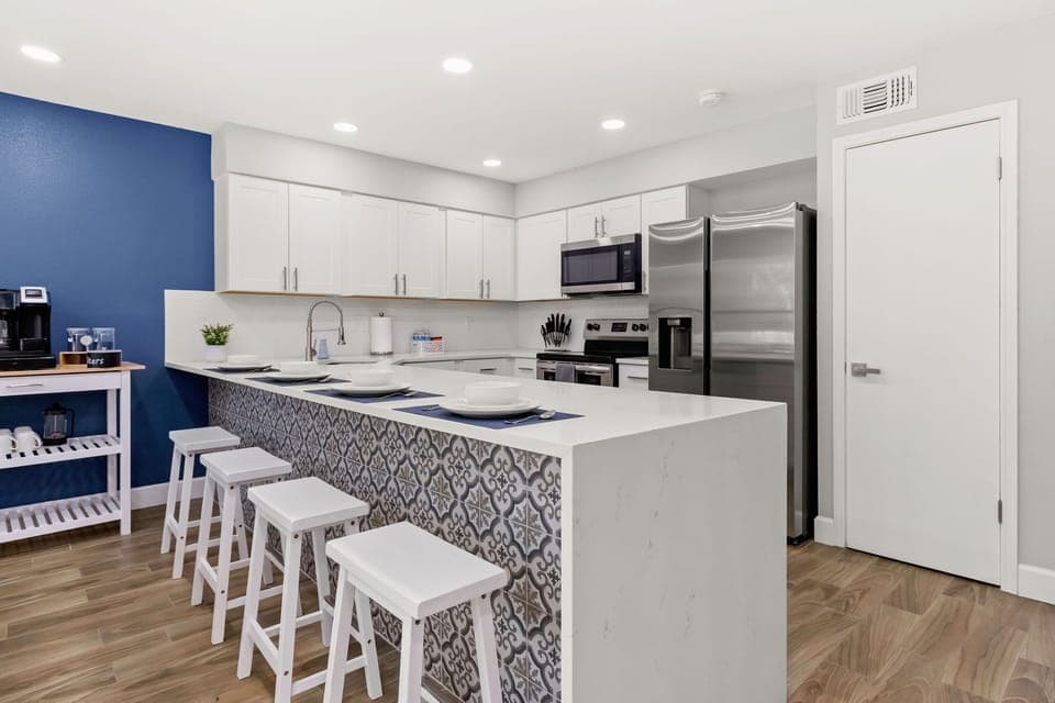 Gather around the stylish kitchen bar, a perfect spot for casual dining, socializing, and enjoying a morning cup of coffee.
