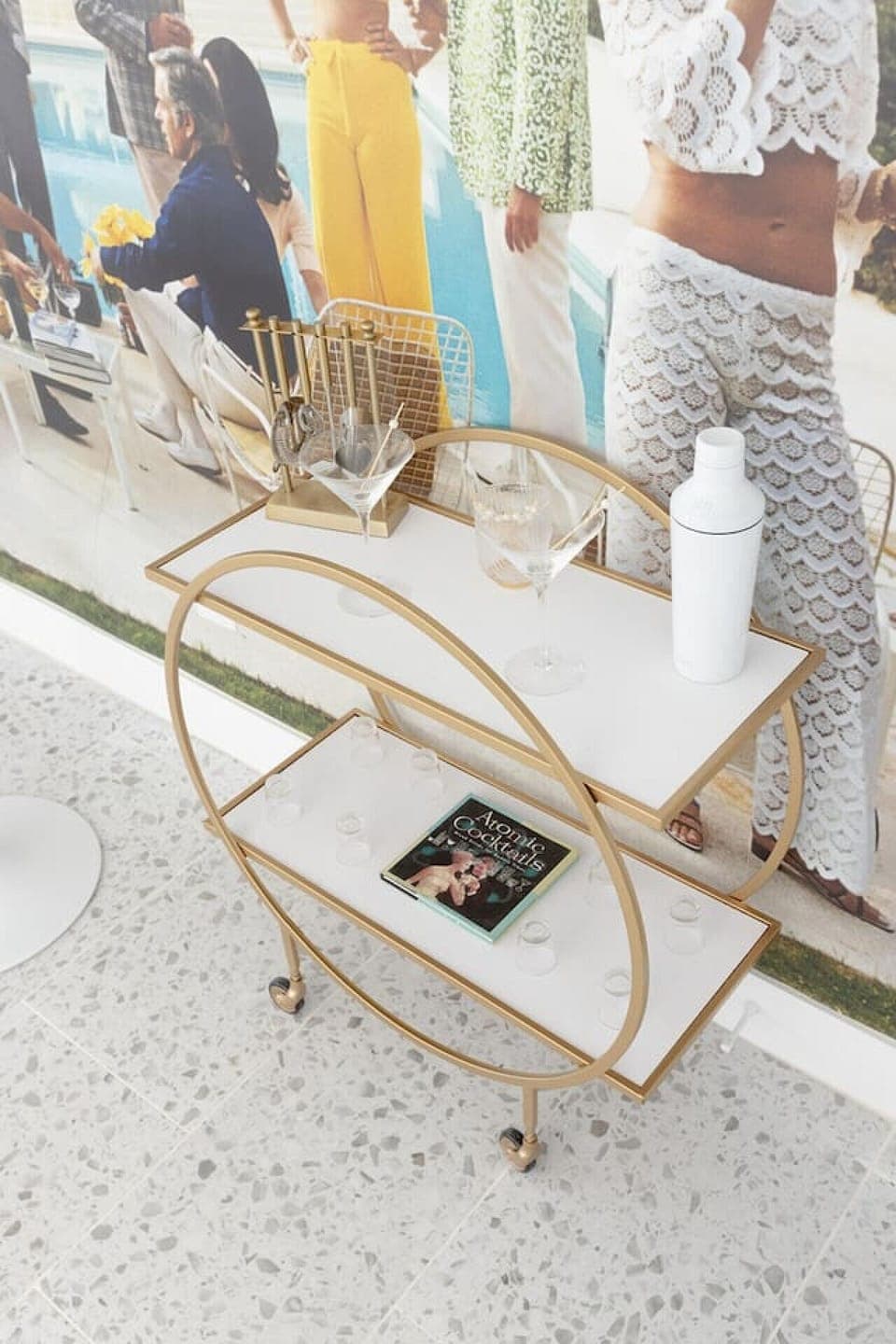 Chic bar cart setup w/ glassware & gold accents, ready for evening cocktails.