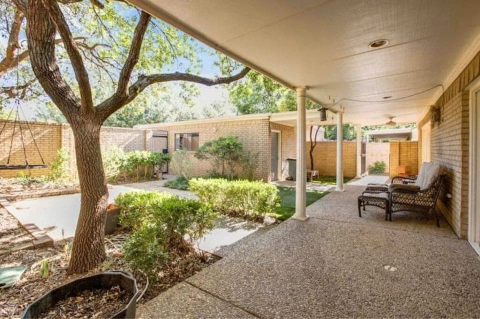 Back patio with tree house, trampoline and smoker